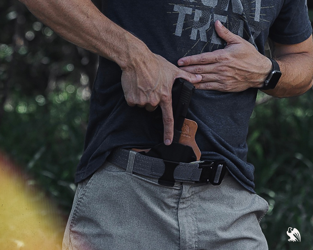 Man ready to draw his handgun out of his holster from Vedder Holsters 