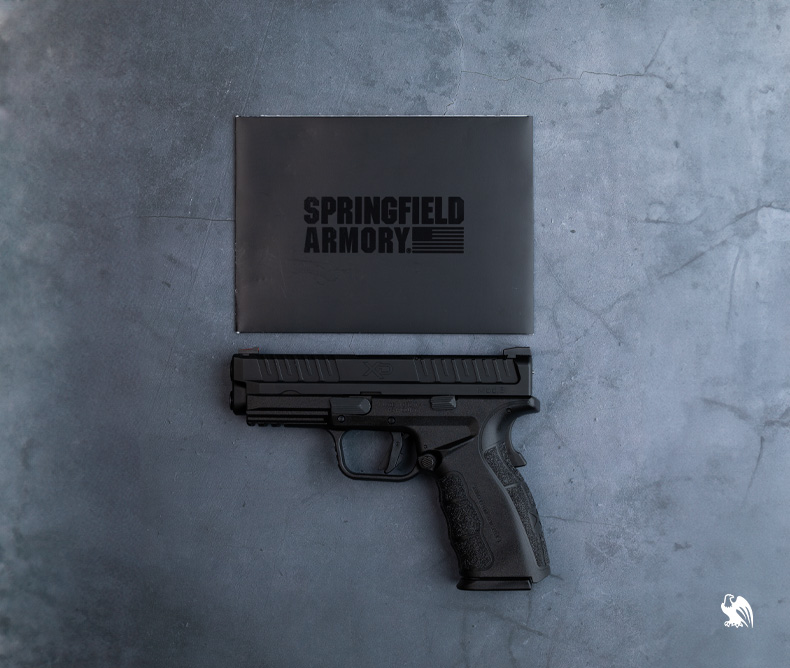 The Springfield Armory XD Mod.3 OSP with a piece of paper that reads the handgun name. 