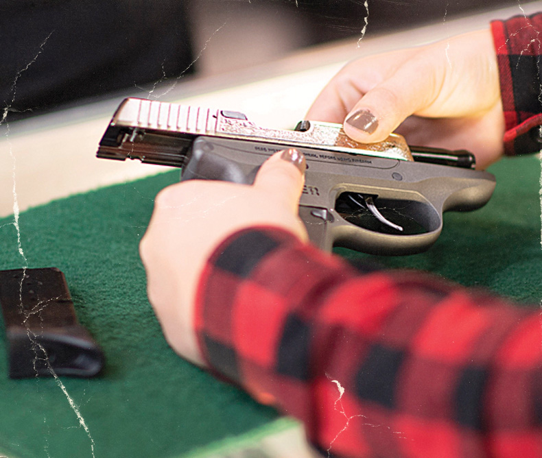 Woman is Inspecting a handgun - Inspecting a used gun