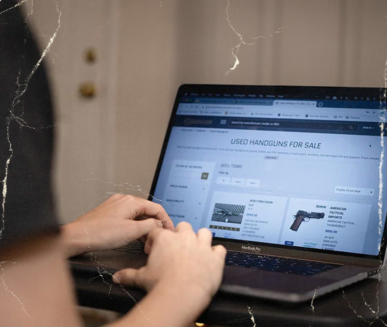 Person shopping on their laptop for used handguns