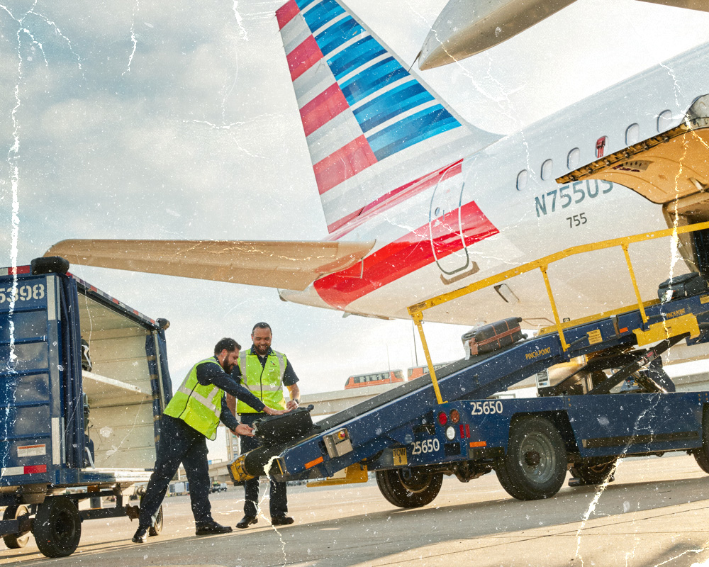 Generic picture of workers at an airport filling up the plane with suitcases.