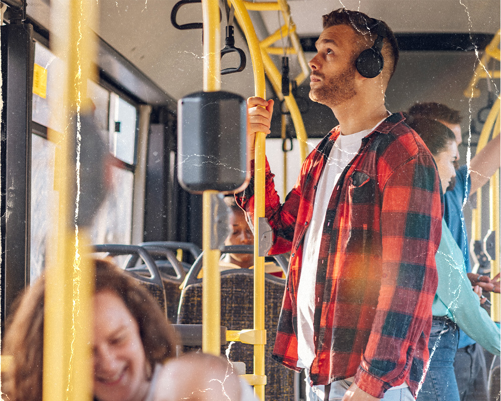 Generic image of a man standing on a public transportation bus.