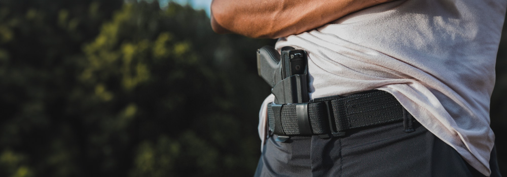 Man wearing a Vedder Holsters Gun Belt while concealed carrying  his handgun on a Vedder Holster.