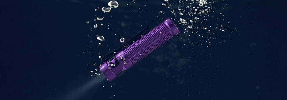 Purple Flashlight floating on water.