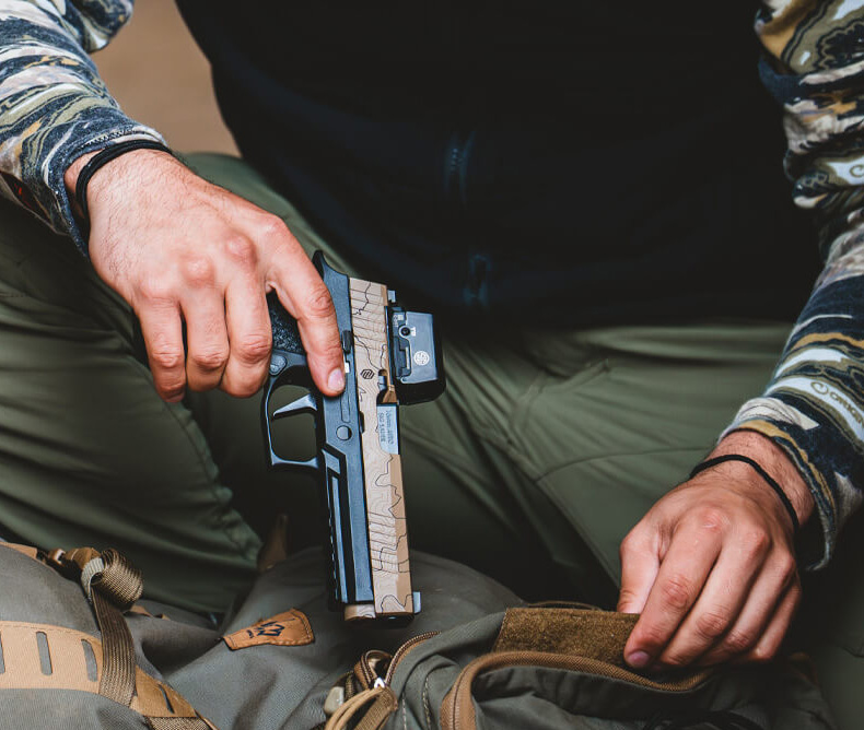 Man holding the new Sig Sauer P320-XTEN Endure Comp