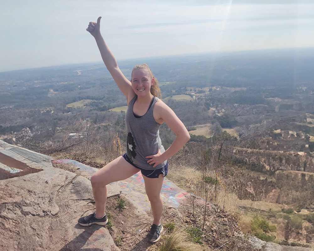 Annika Shoup on top of a mountain.