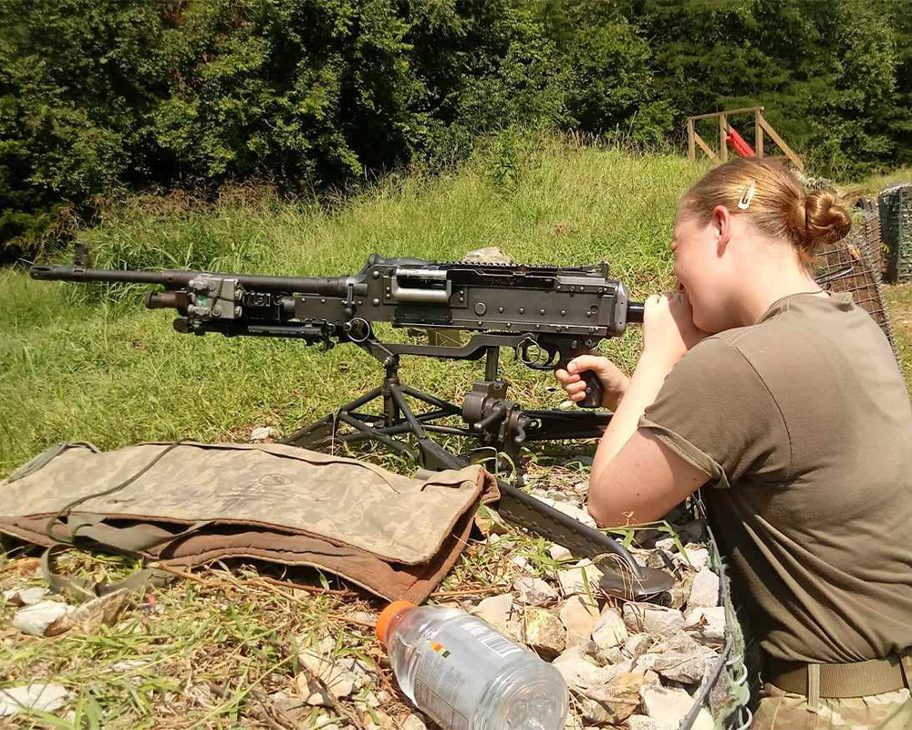 Annika Shoup a Female Infantry soldier firing a machine gun.