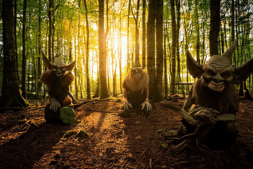 Globlins sitting on rocks on a forest at dusk