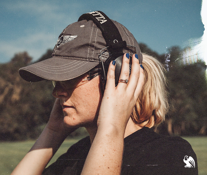 Woman wearing an pair of ear protection providing safety at the shooting range